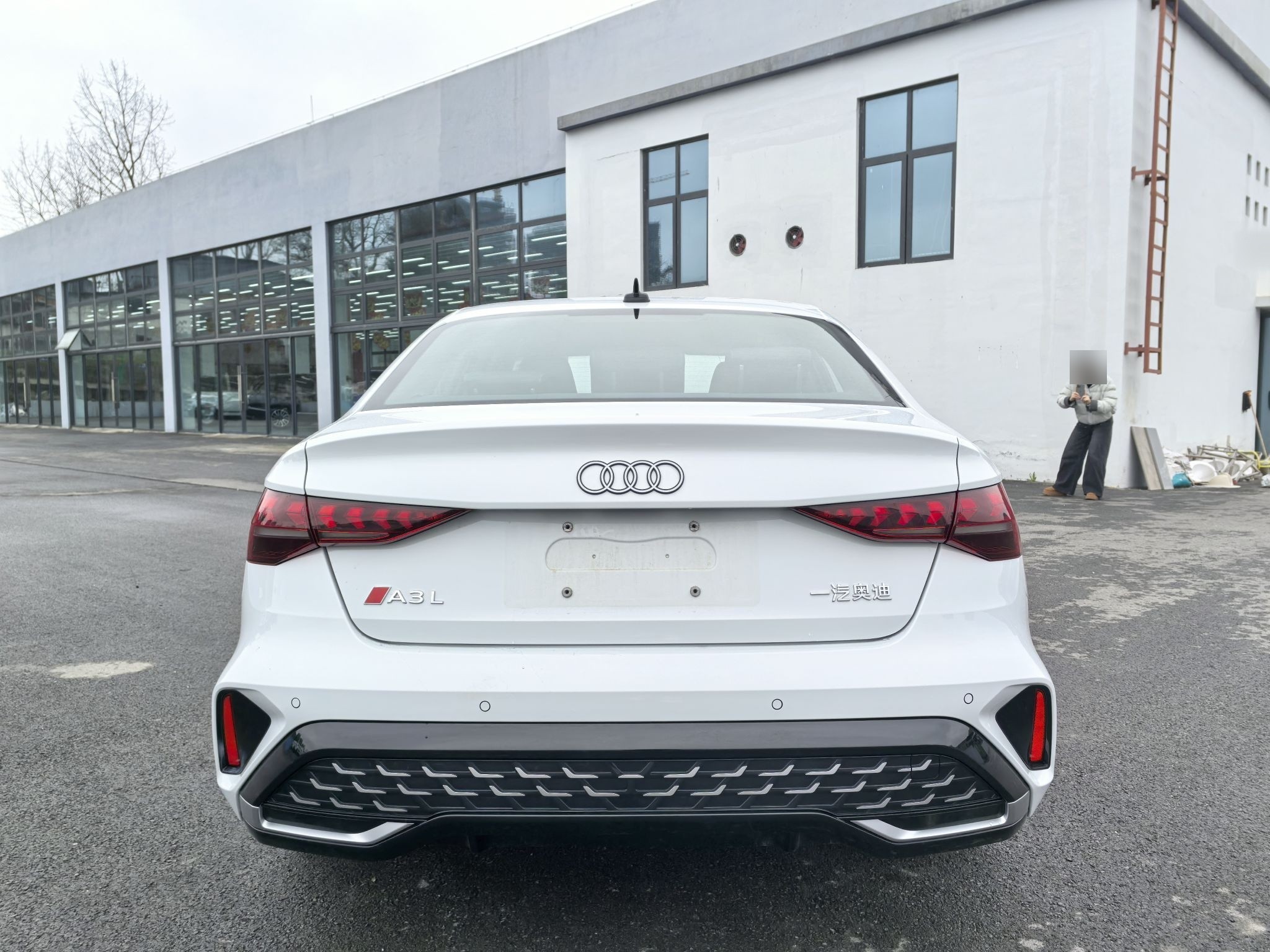 Белый Audi A3 Long сзади на заводской площадке